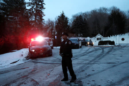 Police vehicles are seen outside the home of former U.S. President Bill Clinton and former Democratic presidential candidate Hillary Clinton after firefighters were called to put out a fire at the property in Chappaqua, New York, U.S., January 3, 2018. REUTERS/Mike Segar