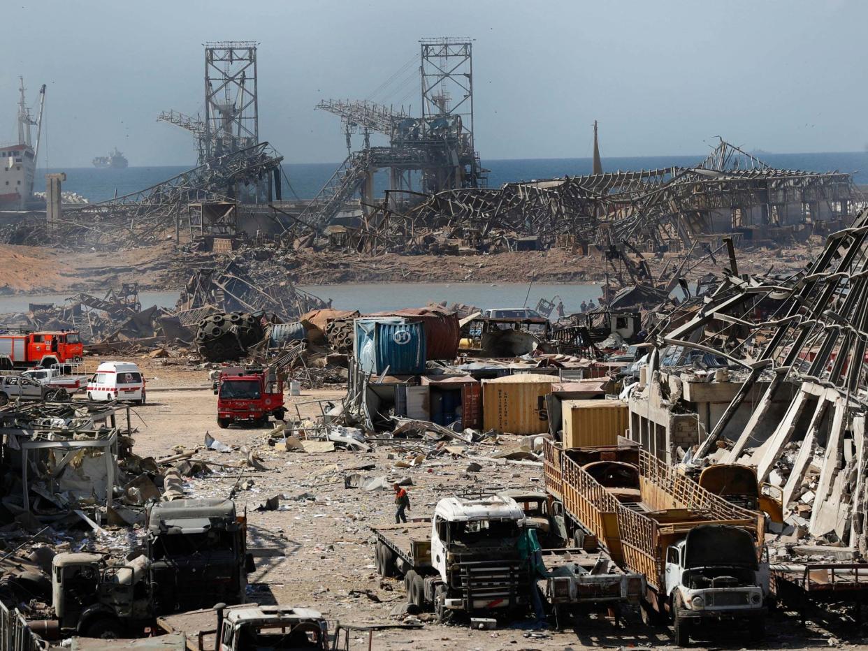 Rescue workers and security officers work at the site of an explosion that hit the seaport of Beirut, Lebanon, 5 August 2020: Hussein Malla/AP