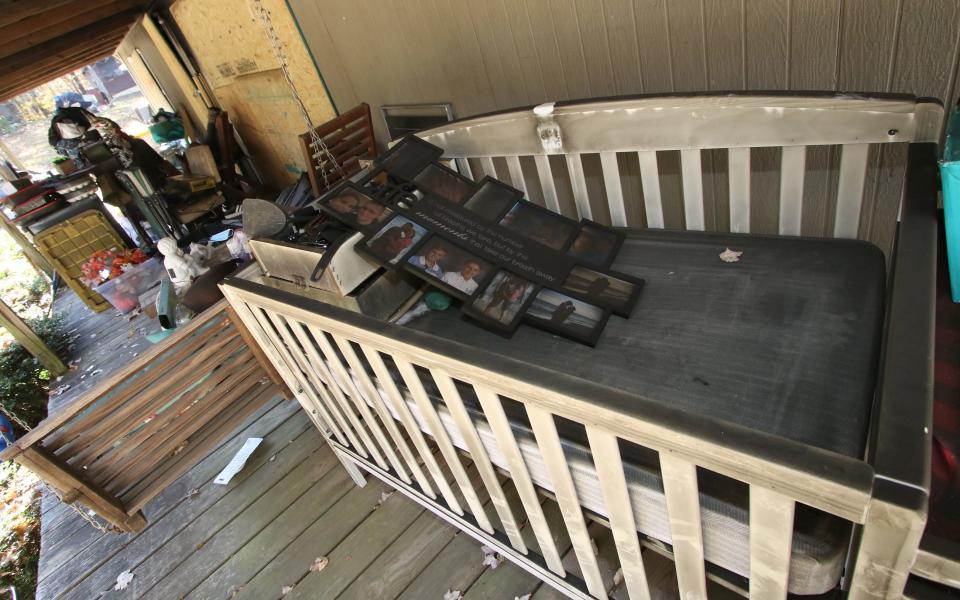 The blackened baby crib sits with other salvaged items on the front porch of the Ray Goodson’s home on Lunsford Drive in Kings Mountain.