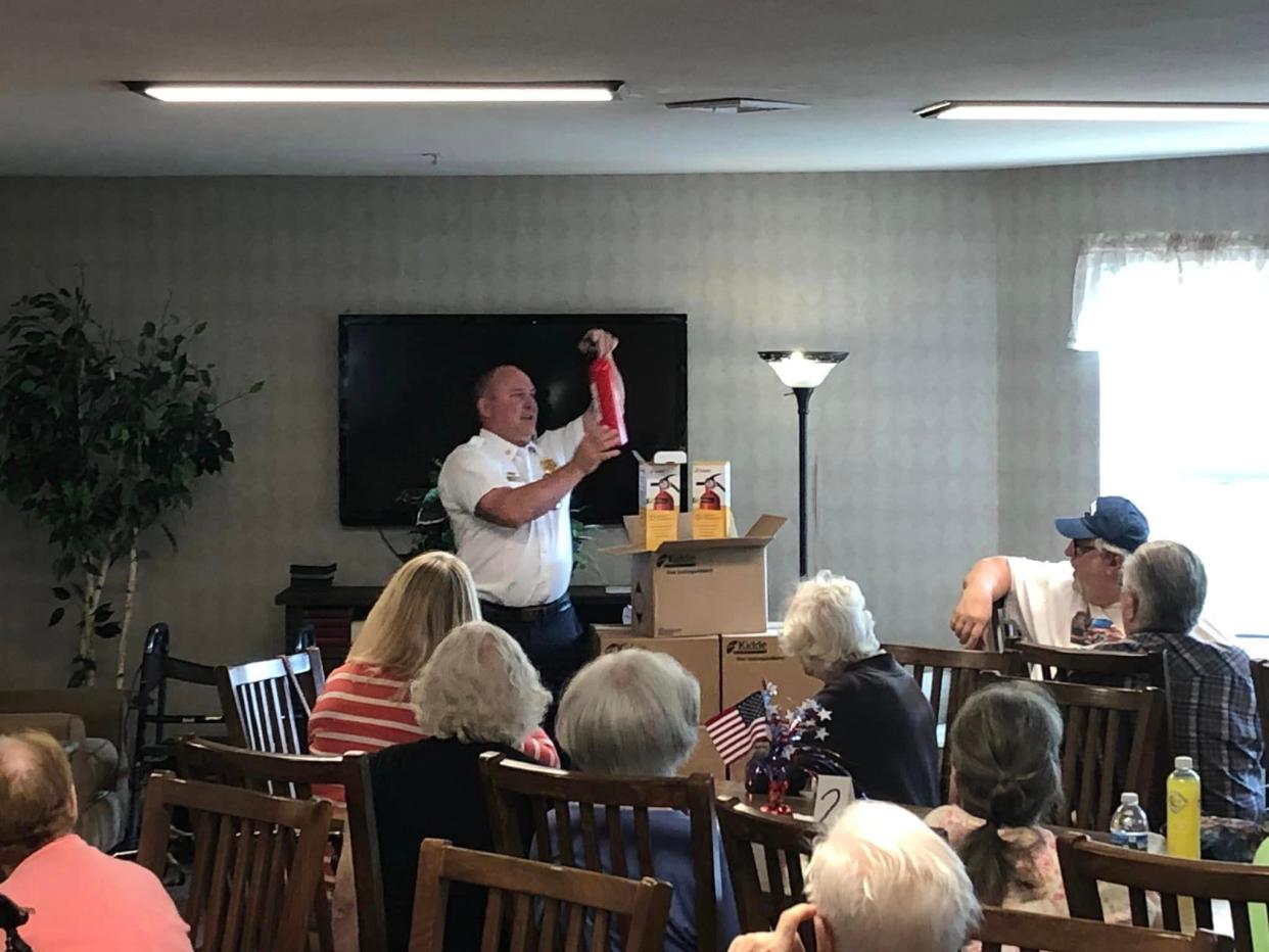 South Milwaukee Fire Chief John Litchford demonstrates the use of a fire extinguisher to a group of seniors at Marquette Manor in June.