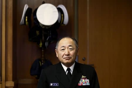 Admiral Katsutoshi Kawano, chief of the Japanese Self-Defense Forces' Joint Staff, poses for pictures after an interview at the Japanese defense ministry in Tokyo November 28, 2014. Japan's highest-ranking military officer on Friday urged an early start to a "crisis management" mechanism with China amid conflicting claims to a group of tiny East China Sea islands. REUTERS/Thomas Peter