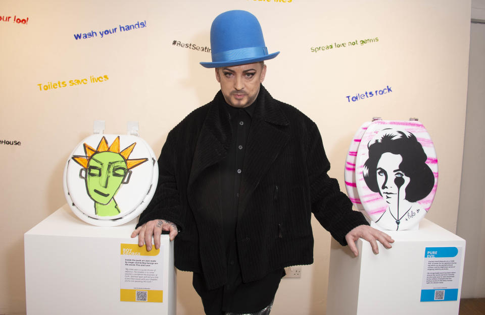 LONDON, ENGLAND - FEBRUARY 03: Boy George poses next to his artwork for the Rankin WaterAid pop-up exhibition launch to celebrate the 'Best Seat In The House' at Gallery @ OXO on February 03, 2022 in London, England. (Photo by Stuart C. Wilson/Getty Images)