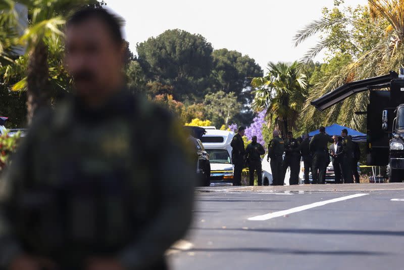 Law enforcement officers are seen after a deadly shooting at Geneva Presbyterian Church in Laguna Woods