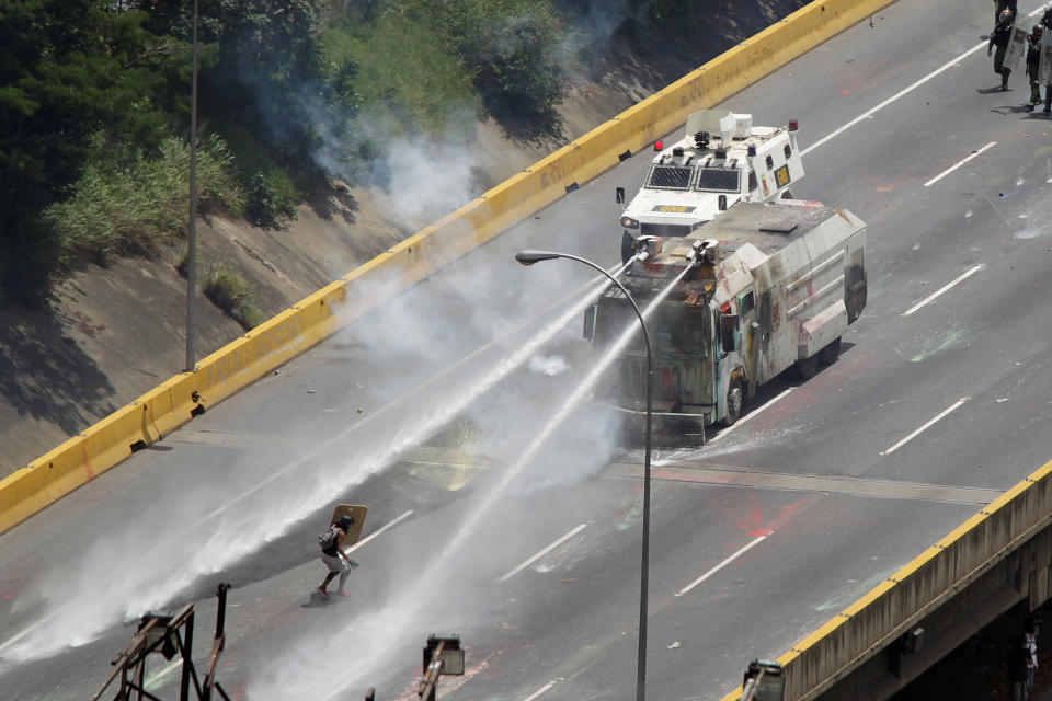 <p>A demonstrator uses a shield as protesters clash with riot security forces during a rally against Venezuela’s President Nicolas Maduro in Caracas, Venezuela, May 26, 2017. (Christian Veron/Reuters) </p>