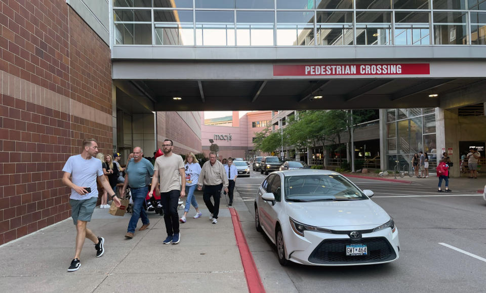 Customers leave the Mall of America after a lockdown was lifted in a shooting, where police have said no victim was found and a suspect has fled, Thursday, Aug. 4, 2022 in Bloomington, Minn. Police in Minnesota confirm that gunshots were fired at the Mall of America in suburban Minneapolis, but say no victim has been found. (AP Photo/Trisha Ahmed)