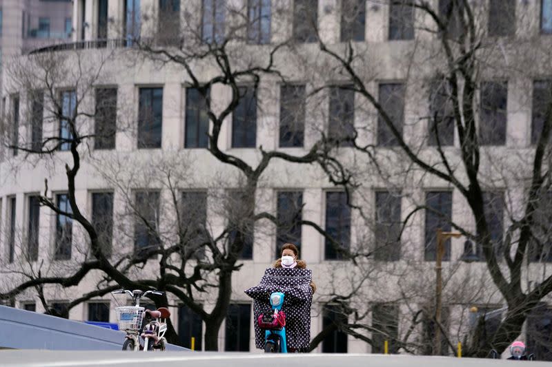 A woman wearing a face mask is seen in downtown Shanghai