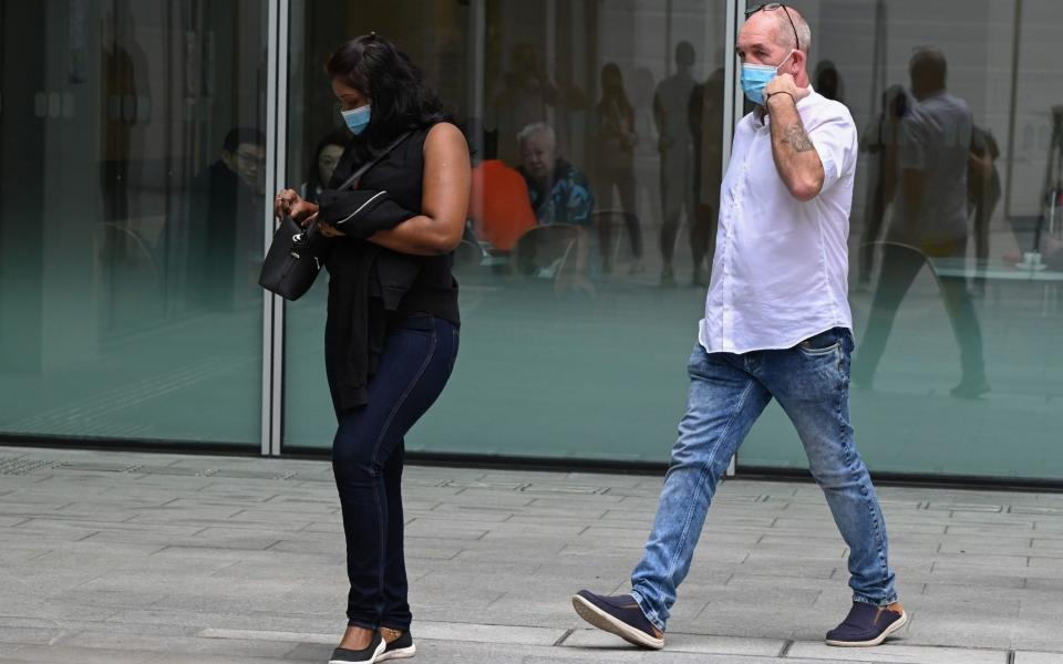 British national Nigel Skea and his wife Agatha Maghesh Eyamalai arrive at the State Court in Singapore - ROSLAN RAHMAN/AFP