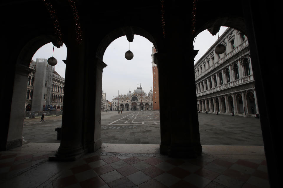A view of an empty St. Mark's Square in Venice, Italy, Saturday, Jan. 30, 2021. Gondolas and other vessels are moored instead of preparing for Carnival's popular boat parade in the lagoon. Alleys are eerily empty. Venetians and the city's few visitors stroll must be masked in public places, indoors and out, under a nationwide mandate. (AP Photo/Antonio Calanni)