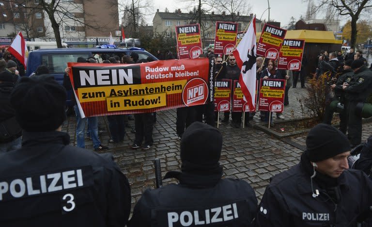 Policemen stand in front of supporters of German far-right party NPD (National Democratic Party of Germany) during a demonstration in Berlin on November 24, 2012. The Philippine government said it would never share power with communist rebels after they proposed an alliance in a bid to end a decades-long insurgency