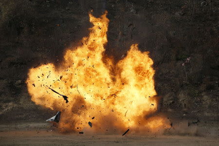 A vehicle is blown up during a course on blast scene investigation near Hua Hin, Thailand January 18, 2016. REUTERS/Jorge Silva