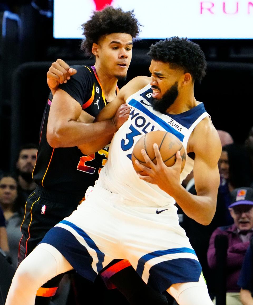 Nov 1, 2022; Phoenix, AZ, USA; Phoenix Suns forward Cameron Johnson (23) pressures Minnesota Timberwolves center Karl-Anthony Towns (32) in the second half at Footprint Center.