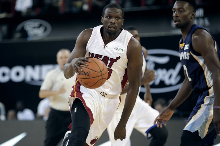 NBA Team Africa's British-South Sudanese captain Luol Deng (L) of Miami Heat dribbles and runs with the ball during the NBA Africa basketball match between Team Africa and Team World on August 1, 2015, in Johannesburg