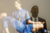 Curator Franklin Sirmans is reflected in "Pieta" by Generic Art Solutions during construction of the exhibition, "Futbol: The Beautiful Game", at the Los Angeles County Museum of Art (LACMA) in Los Angeles, California, January 27, 2014. REUTERS/David McNew