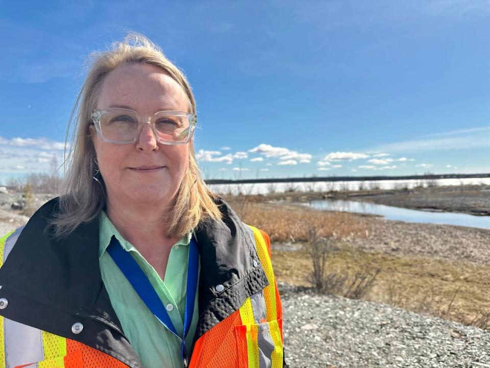 Natalie Plato, the deputy director of the Giant Mine Remediation Project, stands in front of the place where Baker Creek drains into Yellowknife Bay. She said if places like this, where water is used to manage contaminates at former gold mine dry out, they'll start using dust suppression tactics instead.