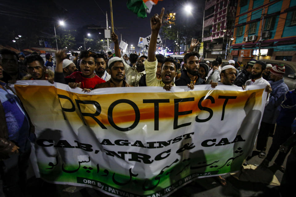 Indians shout slogans during a protest against the Citizenship Amendment Act after Friday prayers outside a mosque in Kolkata, India, Friday, Dec. 20, 2019. Police banned public gatherings in parts of the Indian capital and other cities for a third day Friday and cut internet services to try to stop growing protests against a new citizenship law that have left more than 10 people dead and more than 4,000 others detained. (AP Photo/Bikas Das)