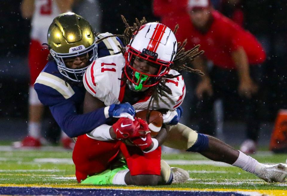 Salesianum's Jasyn Truitt (left) defends as Smyrna's Kahmaj Kearney makes a third quarter reception in Salesianum's 41-40 win in the first round of the DIAA Class 3A tournament, Friday, Nov. 17, 2023 at Abessinio Stadium.