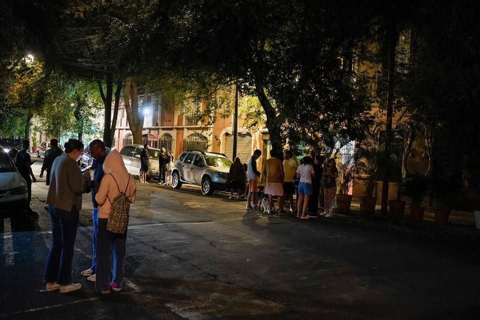 People gather outside after an earthquake was felt in Mexico City, . The earthquake struck early Thursday, just three days after a deadly earthquake shook western and central Mexico