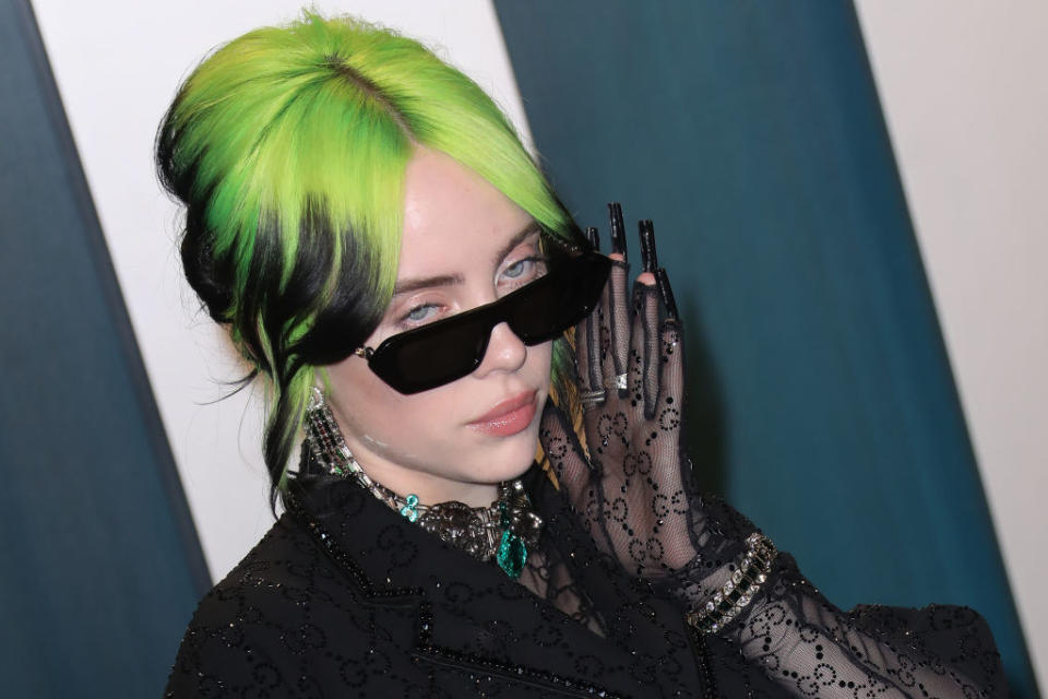 Billie Eilish glancing up through her glasses