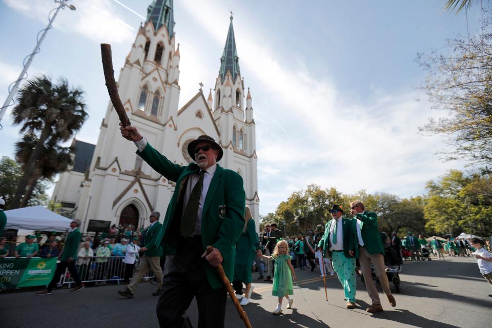 Parade participants march past the Cathedral Basilica of St. John the Baptist on Friday March 17, 2023 during the annual Savannah St. Patrick's Day Parade.
