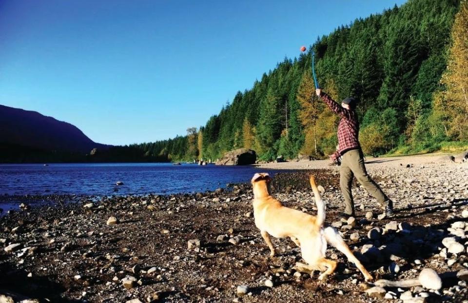 A person and a dog near a lake