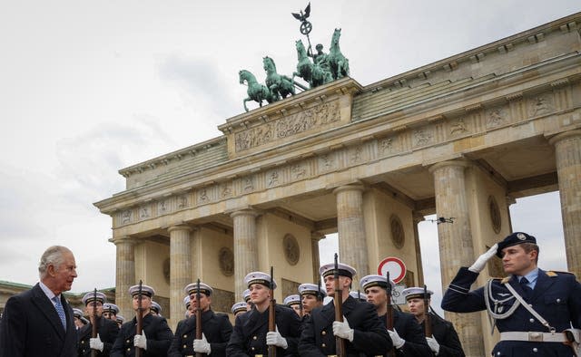 The King inspects a guard of honour during the ceremonial welcome at the Brandenburg Gate, Berlin, at the start of his state visit to Germany 