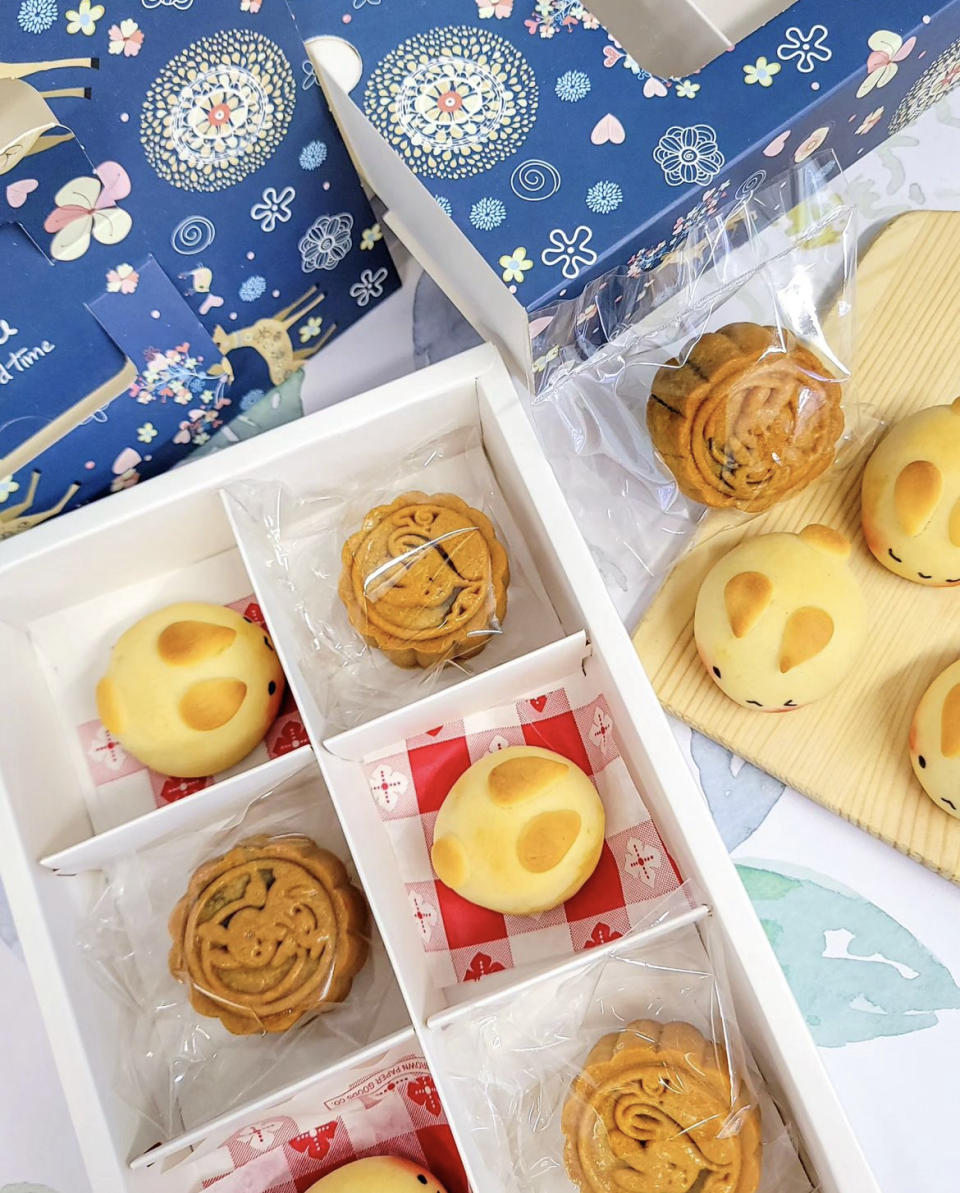 Three mooncakes and three bunny shaped pastries in white box.