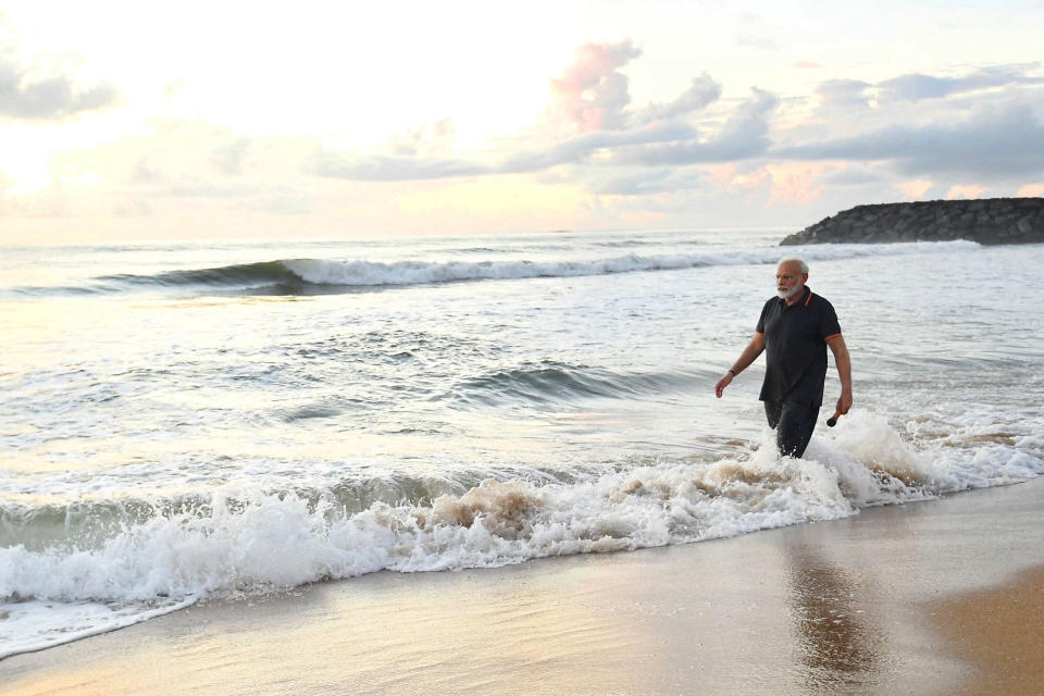 In this photo provided by Prime Minister of India Narendra Modi's twitter handle, Indian Prime Minister Narendra Modi takes morning walk at a beach in Mamallapuram, in southern India, Saturday, Oct. 12, 2019. India's foreign ministry said Chinese President Xi Jinping and Modi met in the seaside temple town of Mamallapuram over dinner for nearly two hours on Friday. The talks will continue Saturday. (Prime Minister of India Narendra Modi's twitter handle via AP Photo)