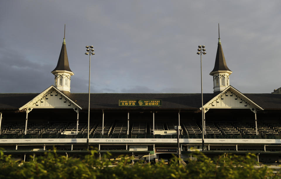 In this May 7, 2020 file photo the sun rises over the track at Churchill Downs in Louisville, Ky. Horse racing is in a state of transition at a time usually reserved for Triple Crown season. The Preakness would have been run Saturday, May 16, 2020 in Baltimore. But Pimlico Race Course and many tracks across North America remain dark because of the coronavirus pandemic. There is some light at the end of the tunnel as tracks including Churchill Downs in Kentucky are getting back to live racing without fans. (AP Photo/Darron Cummings, file)