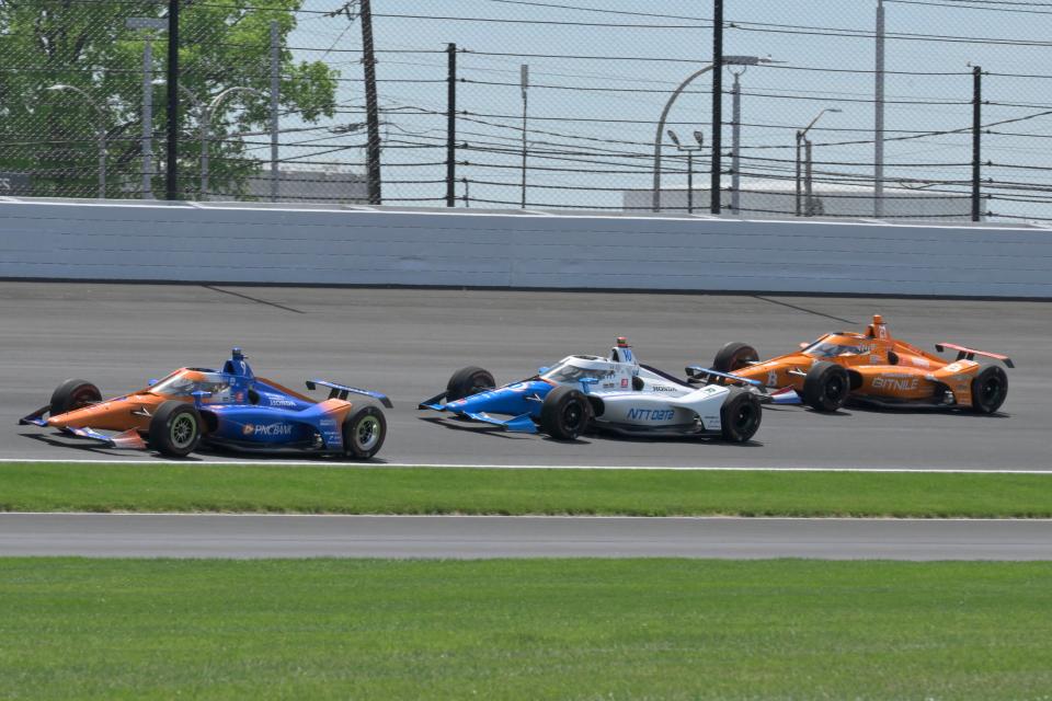 Chip Ganassi Racing driver Scott Dixon (9), Chip Ganassi Racing driver Alex Palou (10) and Ed Carpenter Racing driver Rinus VeeKay (21) move around the track Sunday, May 29, 2022, during the 106th running of the Indianapolis 500 at Indianapolis Motor Speedway