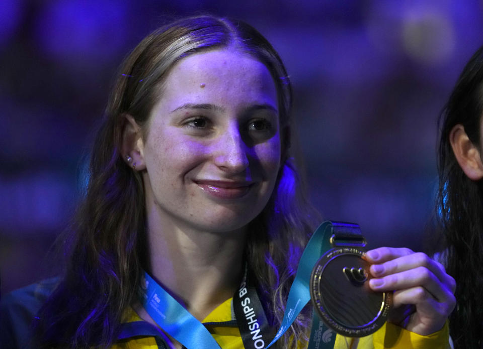 Gold medalist Mollie O'Callaghan of Australia poses with her medal after the Women 100m Freestyle final at the 19th FINA World Championships in Budapest, Hungary, Thursday, June 23, 2022. (AP Photo/Petr David Josek)