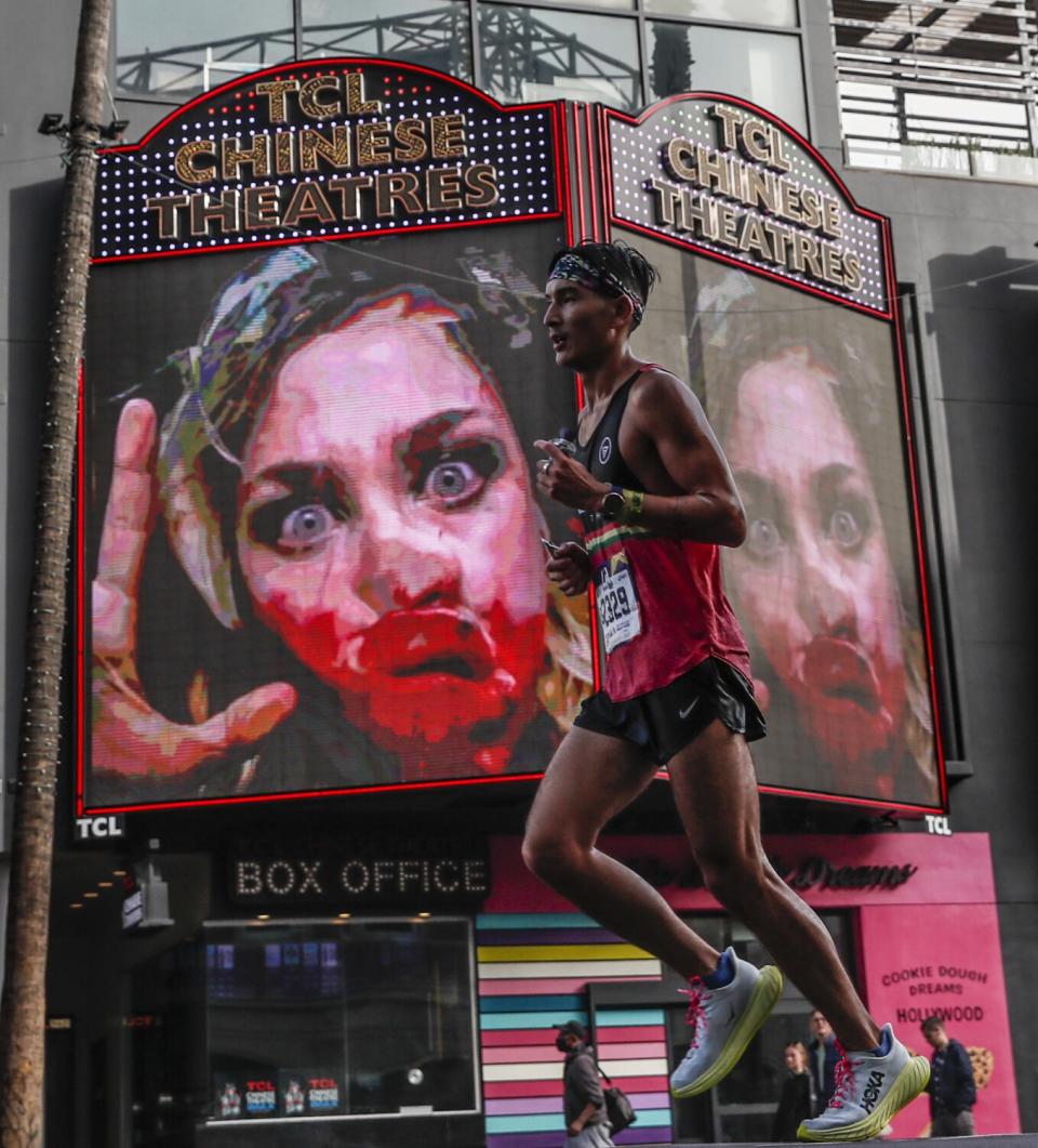 Jared Chan from Brooklyn New York, passes by the TCL Chinese Theatres on Hollywood Boulevard