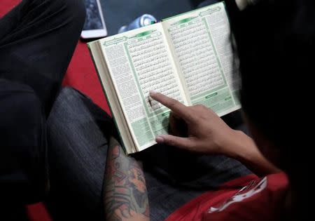 A punk muslim member learns to read the holy Koran at their community house in Bandung, Indonesia West Java province, January 21, 2017. Picture taken January 21, 2017. REUTERS/Beawiharta