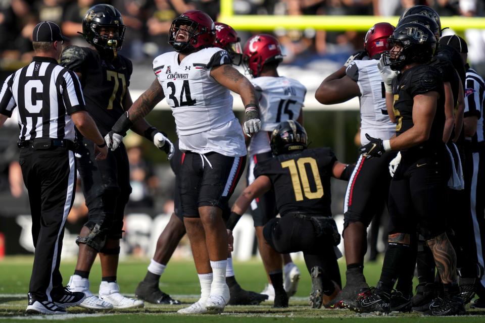 Cincinnati Bearcats defensive lineman Justin Wodtly (34) reacts after a sack of UCF Knights quarterback John Rhys Plumlee (10) in the first quarter during a college football game, Saturday, Oct. 29, 2022, at FBC Mortgage Stadium in Orlando. The Bearcats could use some pressure on Plumlee Saturday in this year's contest between the new Big 12 teams.