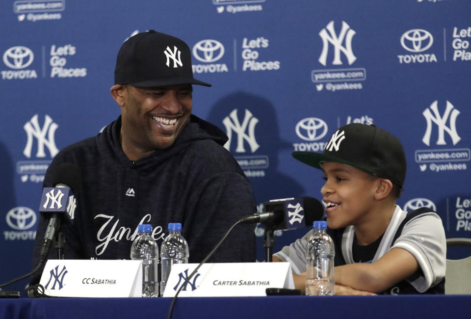 New York Yankees starting pitcher CC Sabathia, pictured with son Carter, received praise from Derek Jeter and LeBron James after confirming plans to retire following 2019 season. (AP)