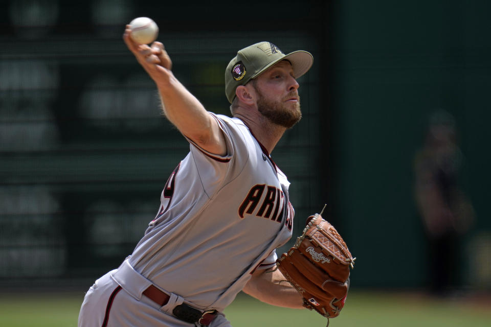 Arizona Diamondbacks starting pitcher Merrill Kelly delivers during the second inning of a baseball game against the Pittsburgh Pirates in Pittsburgh, Sunday, May 21, 2023. (AP Photo/Gene J. Puskar)