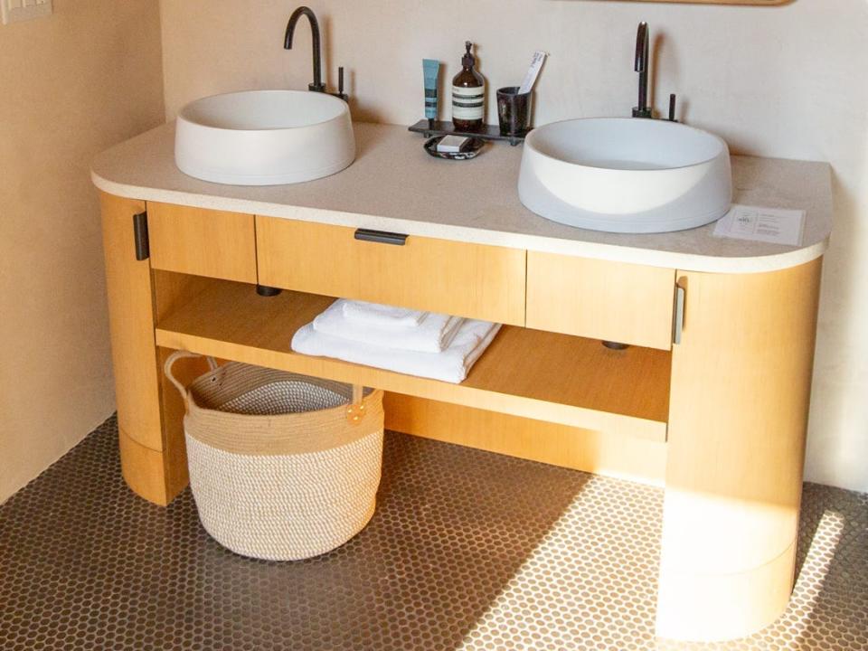 Two sinks and mirrors in a bathroom.