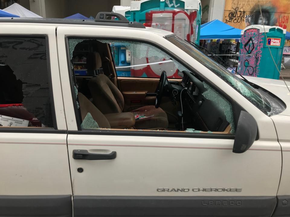 A car sits in the Capitol Hill Organized Protest zone following a shooting in Seattle early Monday, June 29, 2020. At least one man was killed and another was wounded early Monday morning when they were shot in the protest area known as CHOP, after driving the vehicle into the area. (AP Photo/Aron Ranen)