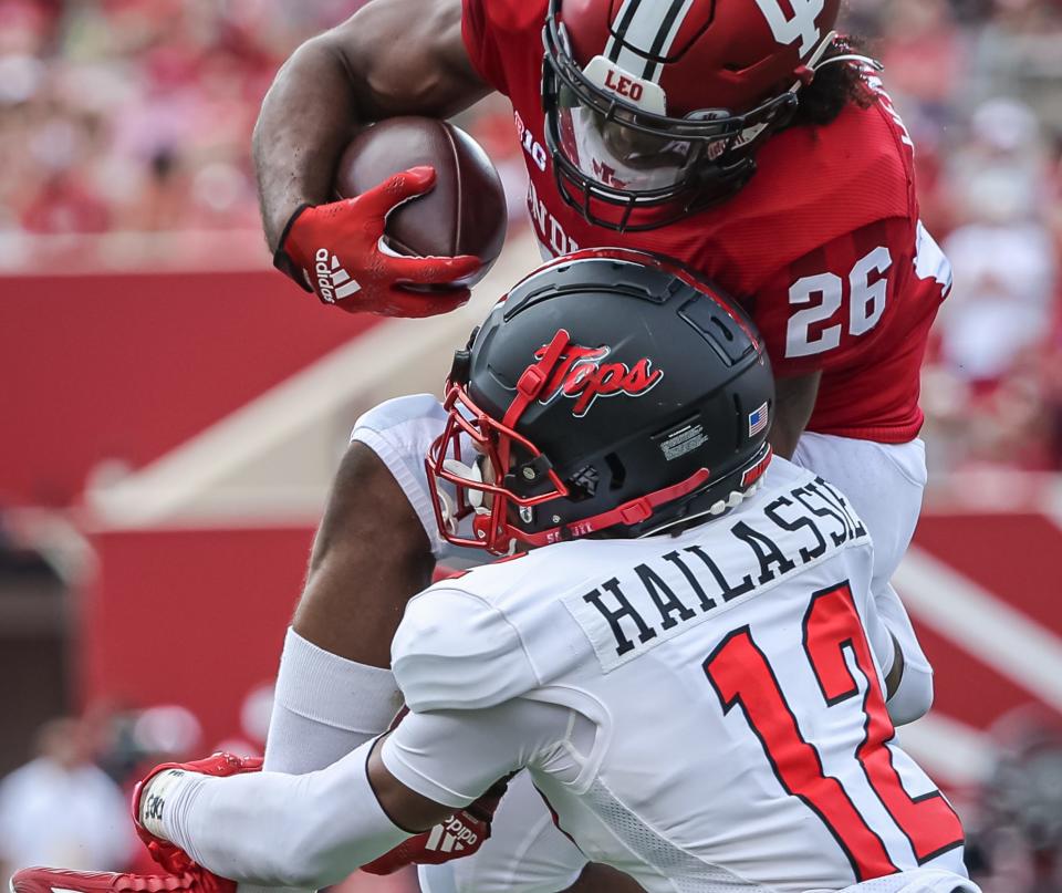 BLOOMINGTON, IN – SEPTEMBER 17: Josh Henderson #26 of the Indiana Hoosiers leaps as Kahlef Hailassie #12 of the Western Kentucky Hilltoppers makes the tackle during the second half at Memorial Stadium on September 17, 2022 in Bloomington, Indiana. (Photo by Michael Hickey/Getty Images)