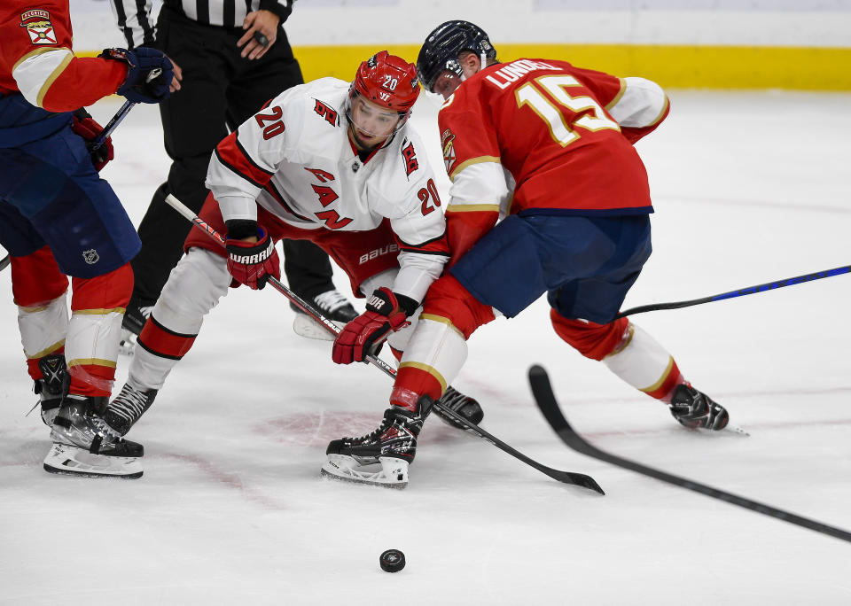 Carolina Hurricanes center Sebastian Aho (20) battles Florida Panthers center Anton Lundell (15) for the puck during the first period of an NHL hockey game, Friday, Nov. 10, 2023, in Sunrise, Fla. (AP Photo/Michael Laughlin)