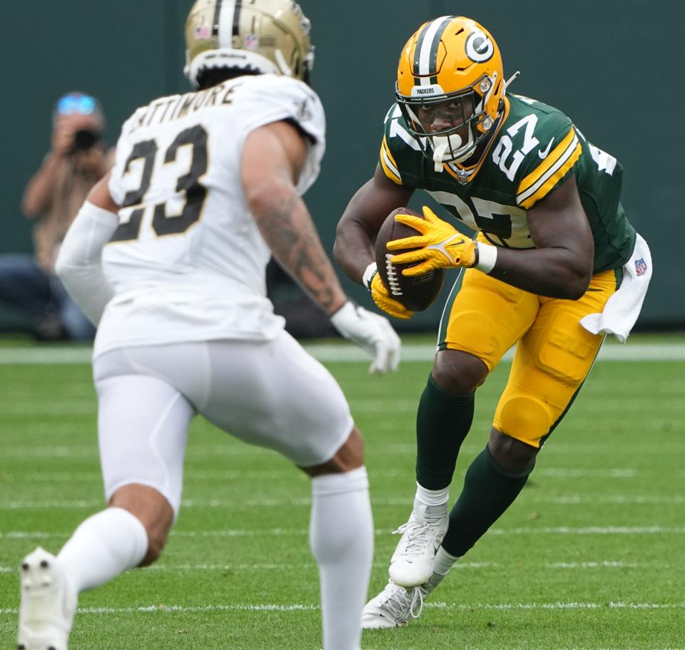 Green Bay Packers running back Patrick Taylor (27) makes a move onNew Orleans Saints cornerback Marshon Lattimore (23) during the third quarter of their game Sunday, September 24, 2023 at Lambeau Field in Green Bay, Wis. The Green Bay Packers beat the New Orleans Saints 18-17.