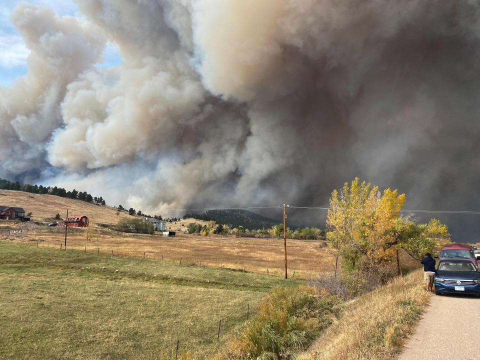 This Saturday Oct. 17, 2020, photo courtesy of Brian DeToy shows a view from the home of Brian DeToy and his wife, Sheryl Shafer, after they were forced to evacuate in Boulder, Colo. Orange skies, winds gusting up to 70 mph, smoke tornadoes and hazardous air. While it could be an apocalyptic scene out of a movie, it's become the reality of Colorado's wildfire season. (Brian DeToy via AP)