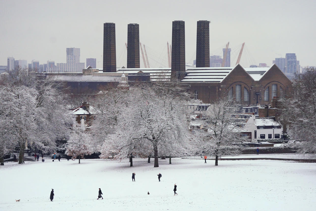 People walk through the snow in Greenwich Park, London. Snow and ice have swept across parts of the UK, with cold wintry conditions set to continue for days. Picture date: Monday December 12, 2022.