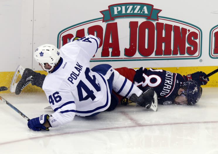 Toronto Maple Leafs defenseman Roman Polak, left, of the Czech Republic, checks Columbus Blue Jackets forward Oliver Bjorkstrand, of Denmark, during the third period of an NHL hockey game in Columbus, Ohio, Wednesday, March 22, 2017. Polak was called for boarding and a game misconduct. The Maple Leafs won 5-2. (AP Photo/Paul Vernon)