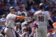 San Francisco Giants' Nick Ahmed (16) is congratulated by Matt Chapman, left, after his sacrifice, which scored Chapman, a during the seventh inning of a baseball game against the Boston Red Sox at Fenway Park, Thursday, May 2, 2024, in Boston. (AP Photo/Charles Krupa)