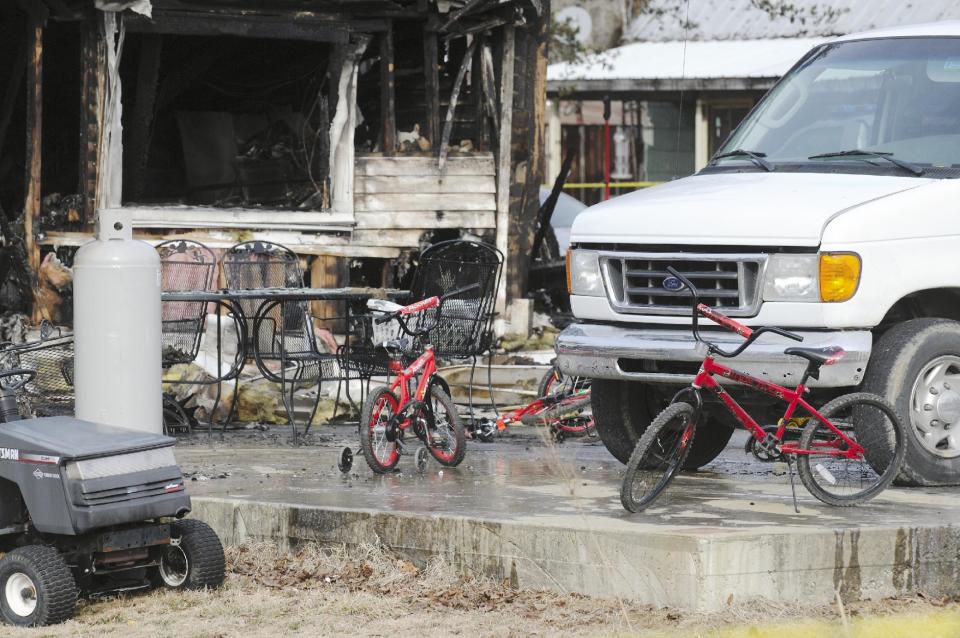 Childrens' bicycles sit in front of remains of home after an early morning fire in Greenville, Ky., Thursday Jan. 30, 2014. Remains of 6 people have been recovered from the rubble and 3 additional people are missing. (AP Photo/The Gleaner, Mike Lawrence)