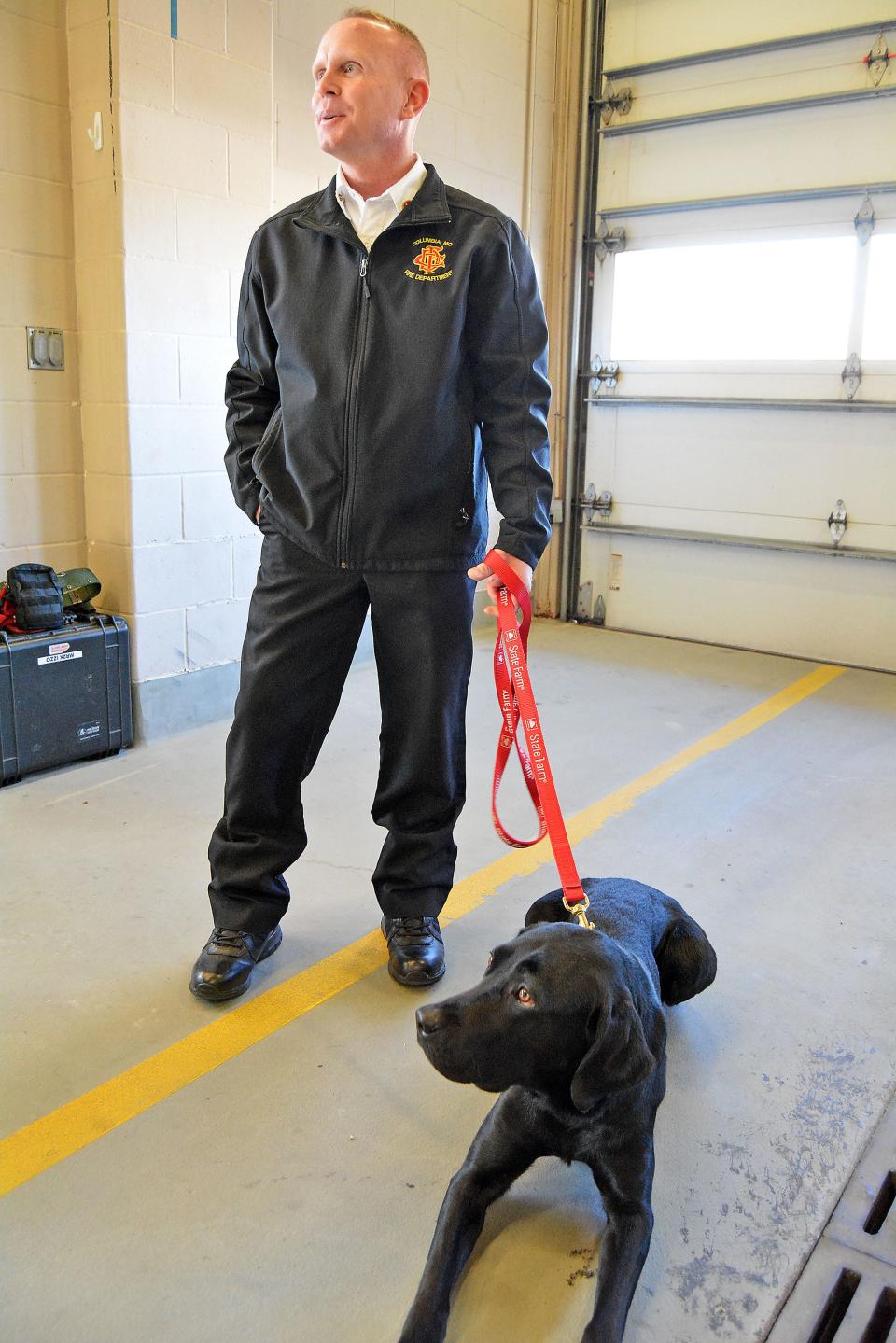 Columbia Fire Deparment Fire Marshal Battalion Chief Jim Pasley stands with the department's new accelerant detection go Tony on Friday at the department's downtown headquarters.