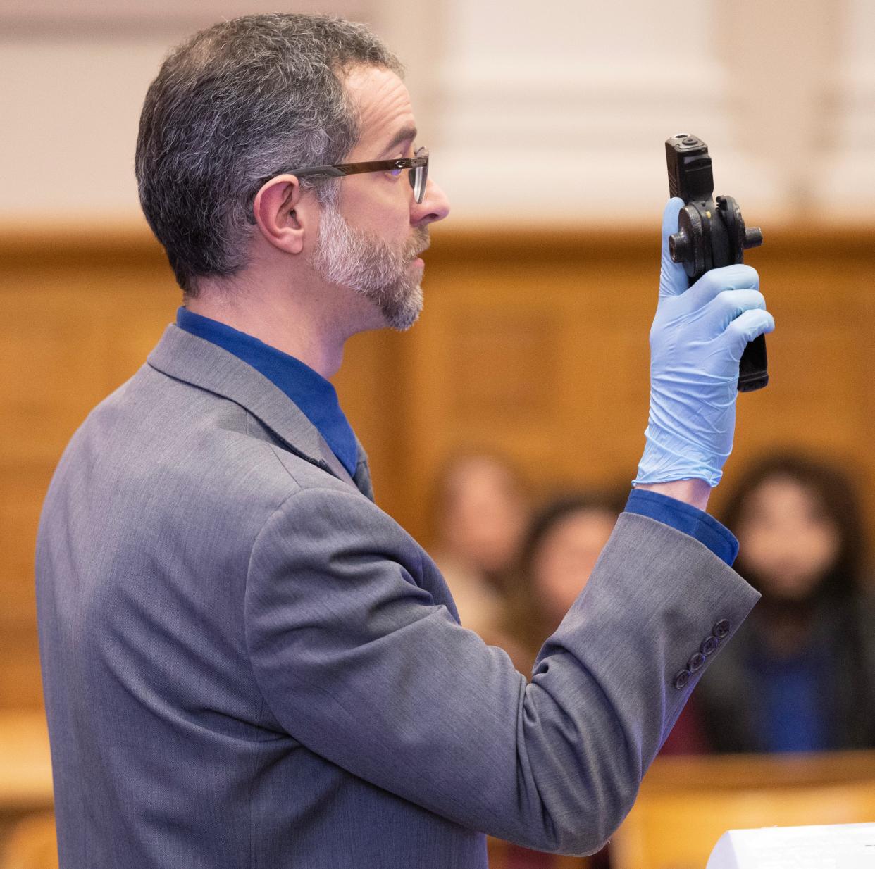 During his opening statement at Willis R. Kennedy's trial, defense attorney Anthony Wise shows the gun that was pulled on his client by Keith D. Greggs. The murder trial started Monday before Judge Natalie R. Haupt in Stark County Common Pleas Court,