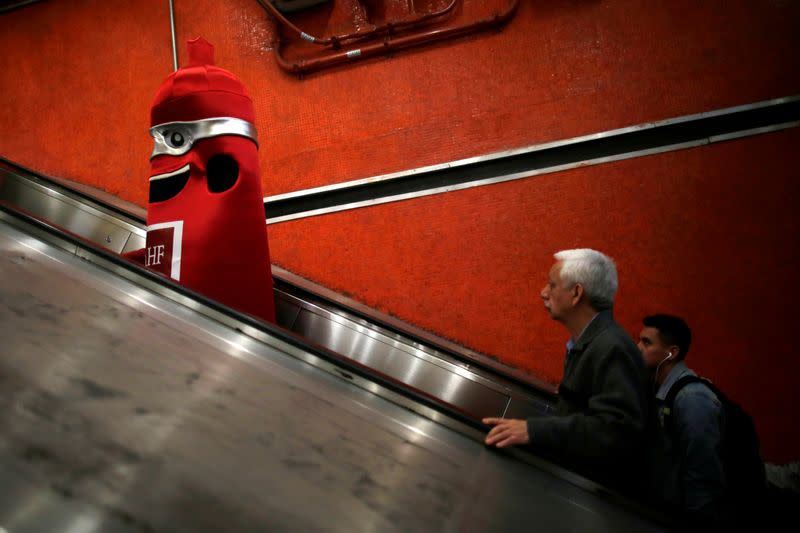 A man wearing a condom costume is seen inside the metro on International Condoms Day, celebrated a day before Valentine Day, in Mexico City