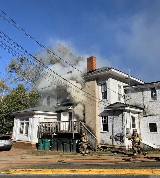 Firefighters responded to this house on South Milledge Avenue Wednesday, where two residents were treated for smoke inhalation and two cats were rescued from an upstairs room.