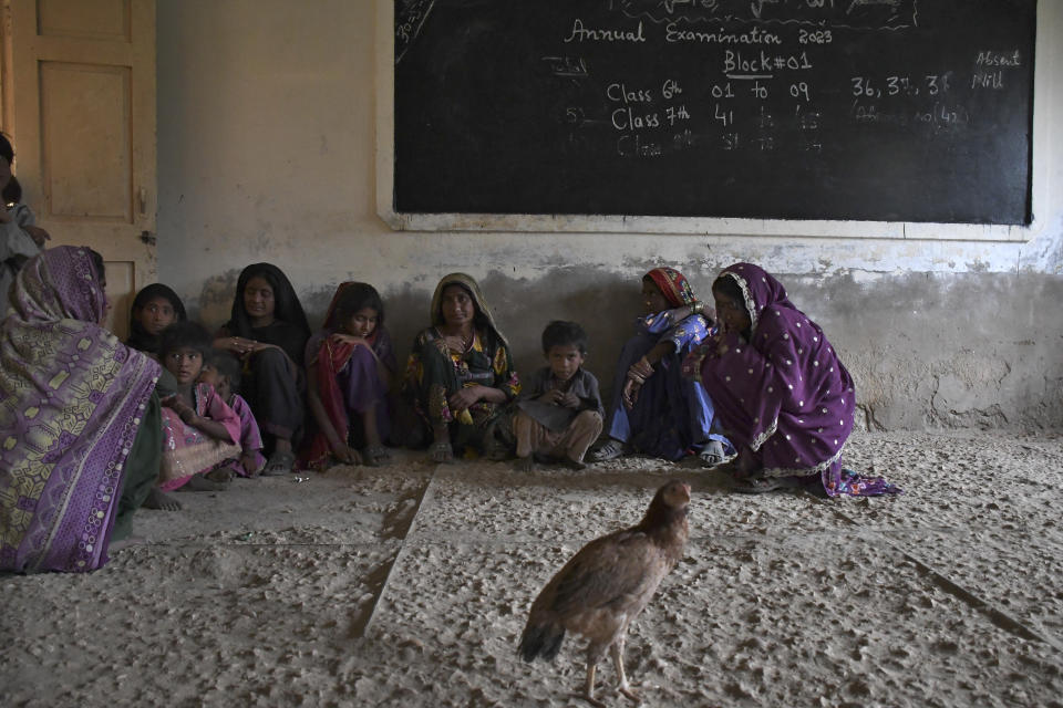 Women and children take shelter in a school building after fleeing from their villages due to Cyclone Biparjoy approaching, at a costal area of Badin district, in Pakistan's Sindh province, Tuesday, June 13, 2023. Pakistan's army and civil authorities are planning to evacuate 80,000 people to safety along the country's southern coast, and thousands in neighboring India sought shelter ahead of Cyclone Biparjoy, officials said. (AP Photo/Umair Rajput)
